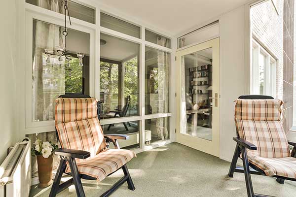 Interior of a sunroom with two chairs