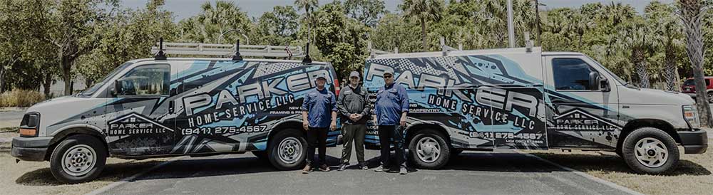 Parker home service crew posing for a photo op in front of their company vans